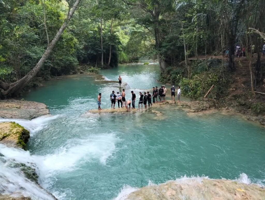 Traveler exploring a secluded waterfall in rural Flores