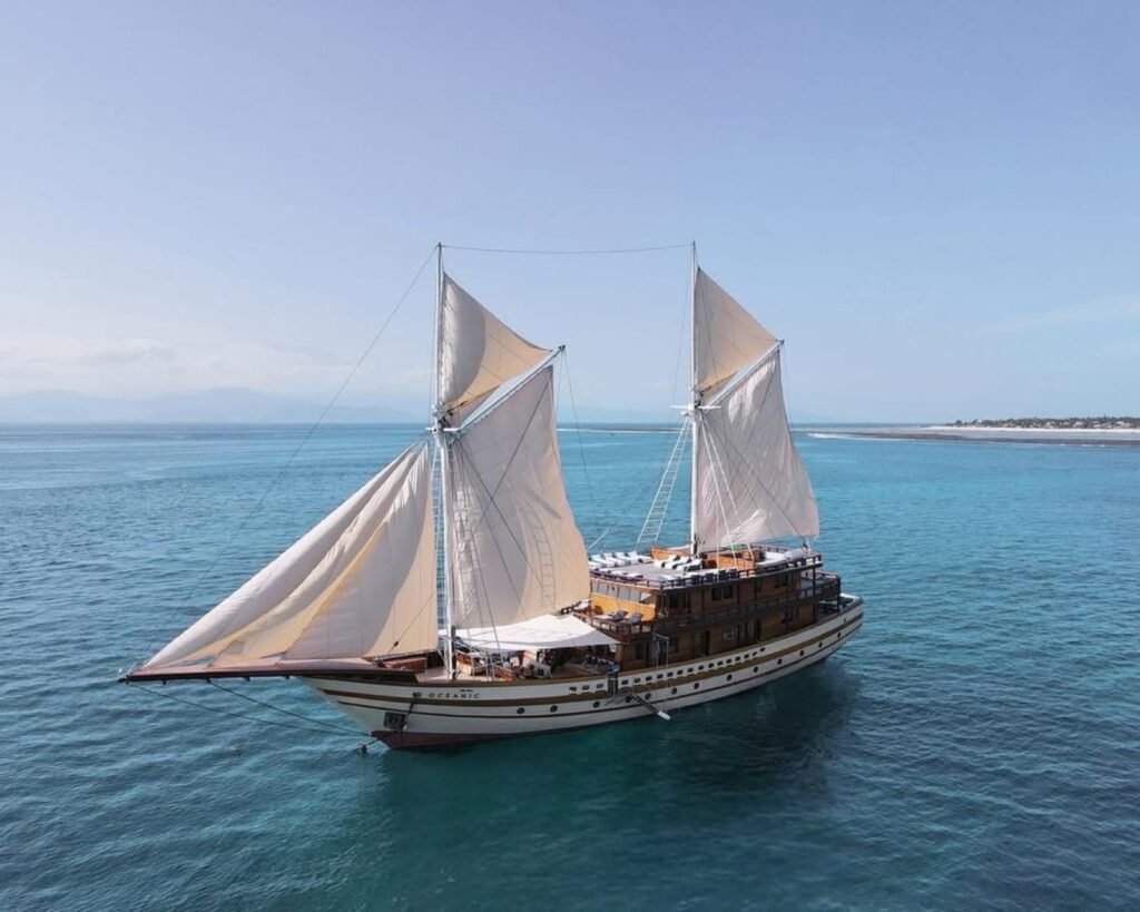 Komodo Luxury Cruise experience with Flores Pristine Tour, featuring elegant yacht, scenic islands, and premium onboard services in Komodo National Park.