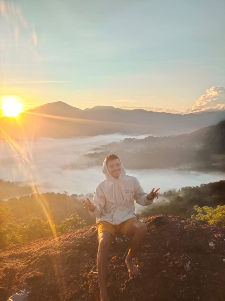 Morning sun rising above Watu Benta cliffs in Golo Lajang Village, Flores, Indonesia.