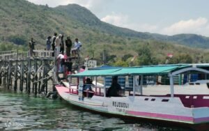 Traditional wooden boat sailing to Rangko Cave in Flores, Indonesia