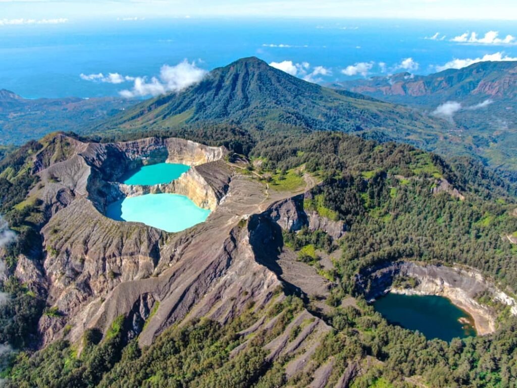 Scenic view of Kelimutu National Park with its three-colored crater lakes during sunrise.