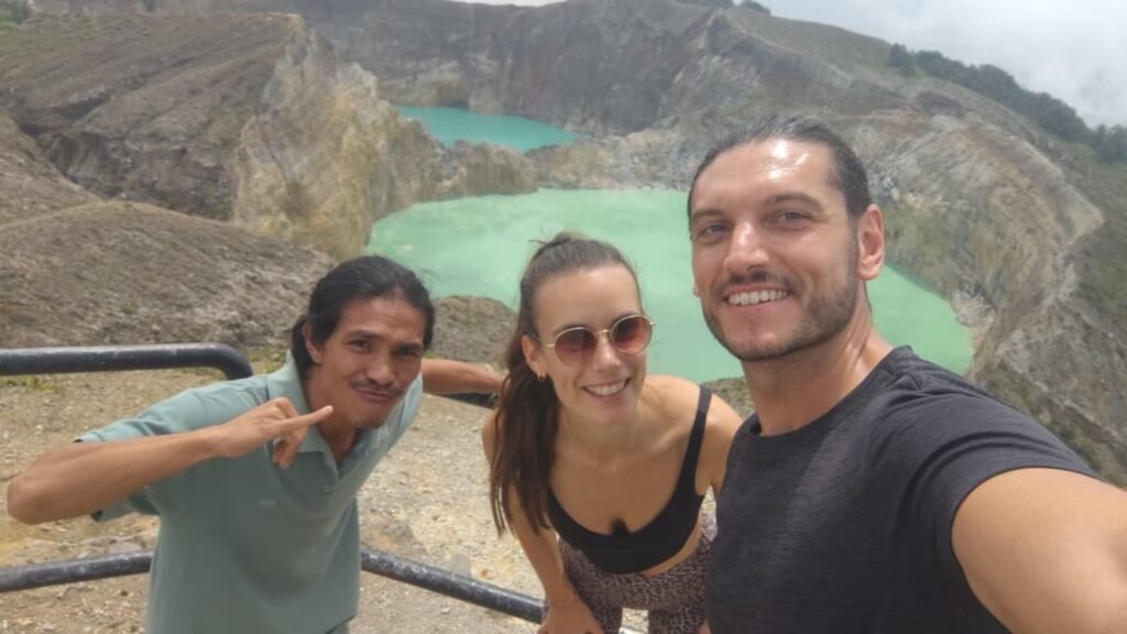 Tourists enjoying sunrise at the three colored crater lakes during Kelimutu Tour Package with Flores Pristine Tour in Flores Indonesia