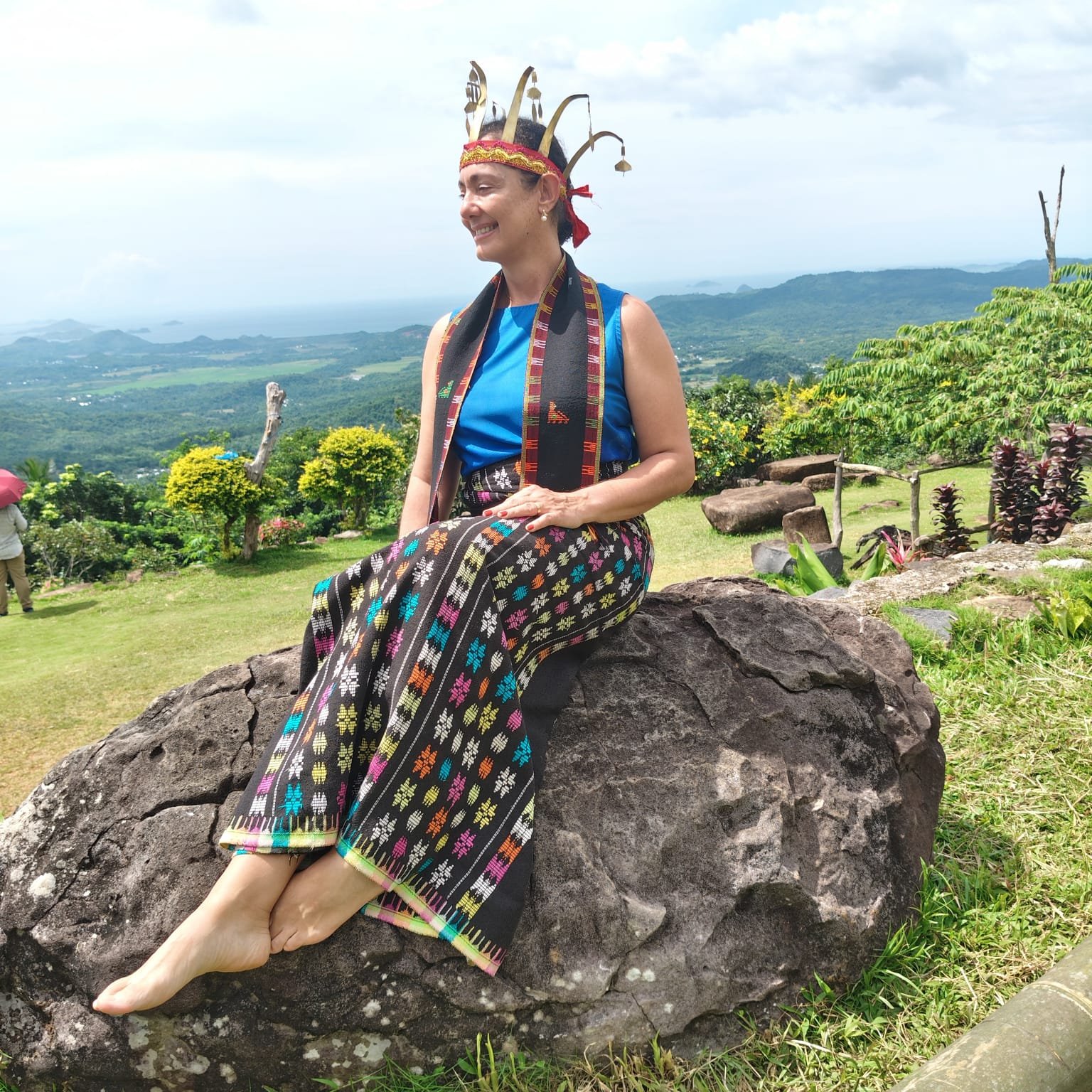 Visitor from Brazil wearing traditional Manggarai clothing at Melo Village Labuan Bajo custom tour experience