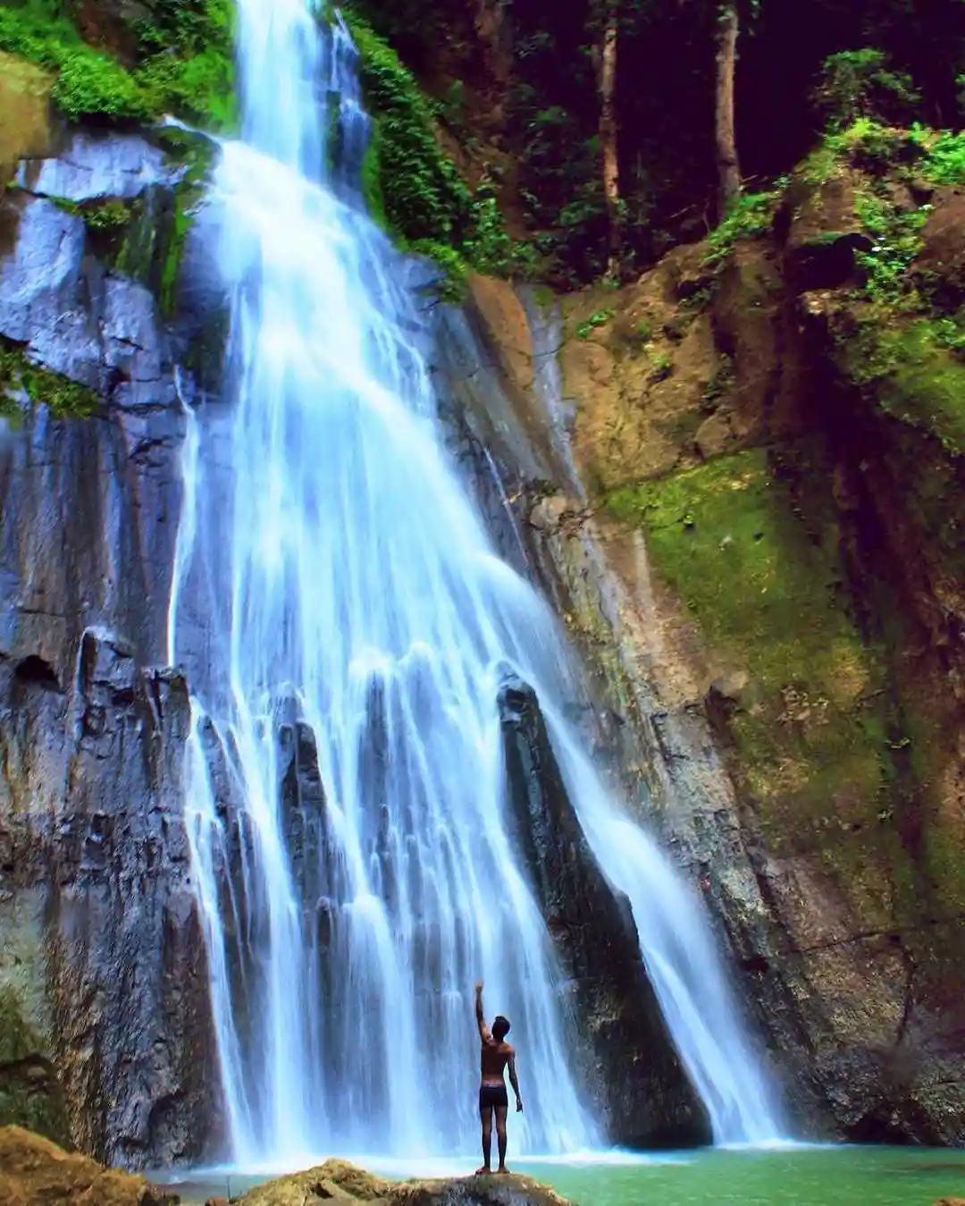Mataru Waterfall the highest waterfall in Alor cascading from tall cliffs surrounded by lush green forest in Pulau Alor Indonesia