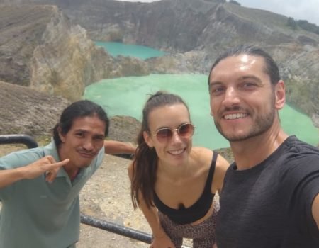 Tourists enjoying sunrise at the three-colored crater lakes during Kelimutu Tour Package with Flores Pristine Tour in Flores, Indonesia