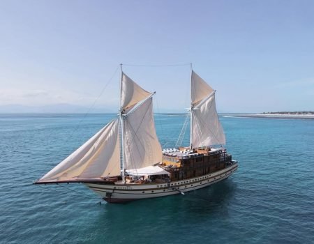 Komodo Luxury Cruise experience with Flores Pristine Tour, featuring elegant yacht, scenic islands, and premium onboard services in Komodo National Park.