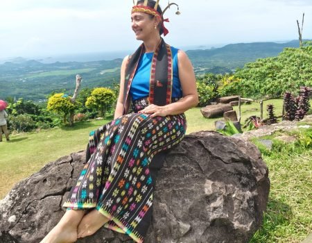 Visitor from Brazil wearing traditional Manggarai clothing at Melo Village, Labuan Bajo custom tour experience