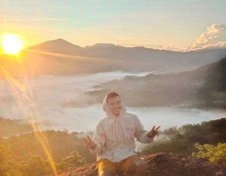 Morning sun rising above Watu Benta cliffs in Golo Lajang Village, Flores, Indonesia.