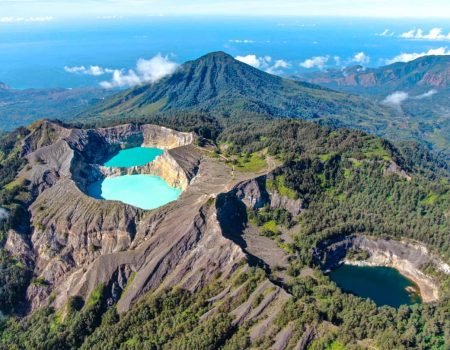 Scenic view of Kelimutu National Park with its three-colored crater lakes during sunrise.